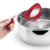 Cuisipro egg silicone poacher set of 2 in red - product image of a poached egg being lifted out of water Danielle Walker